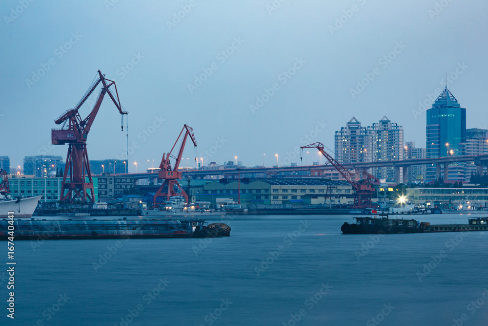 Ships on Huangpu River and cranes at the harbour,shanghai,china.