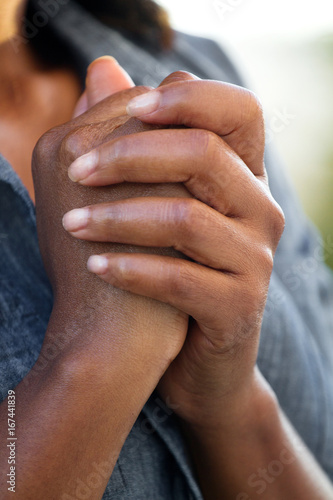 Closeup of a woman praying.