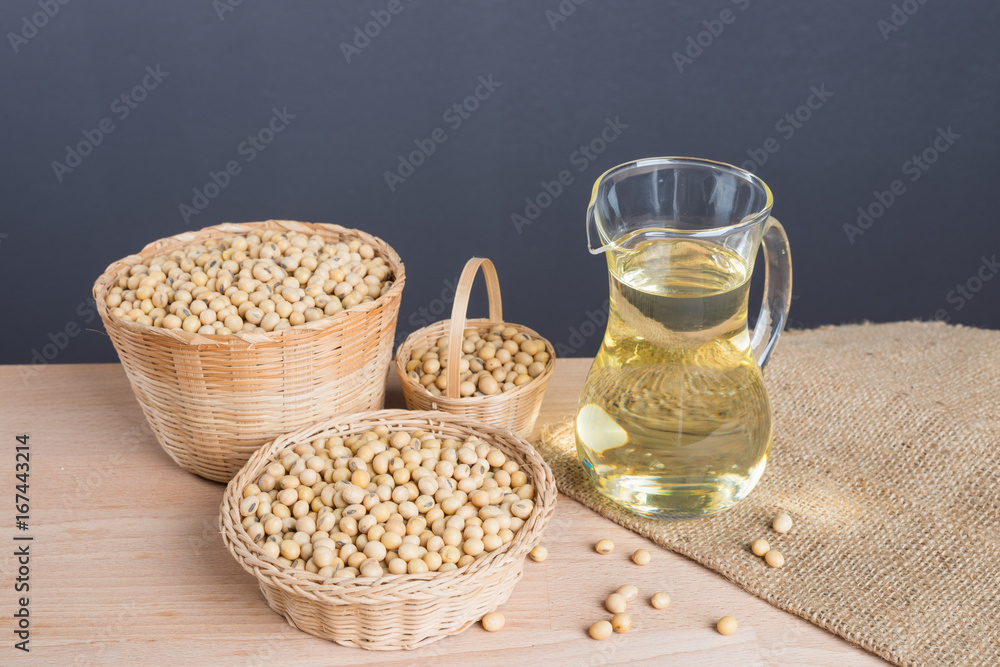 Soybean and soybean oil in jar on wood Soybean and soybean oil in jar on wood