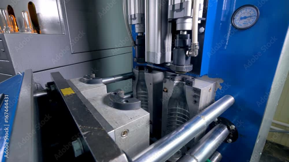 Fast motion captures blow-molding process in detailed view. Fast motion captures blow-molding process in detailed view.