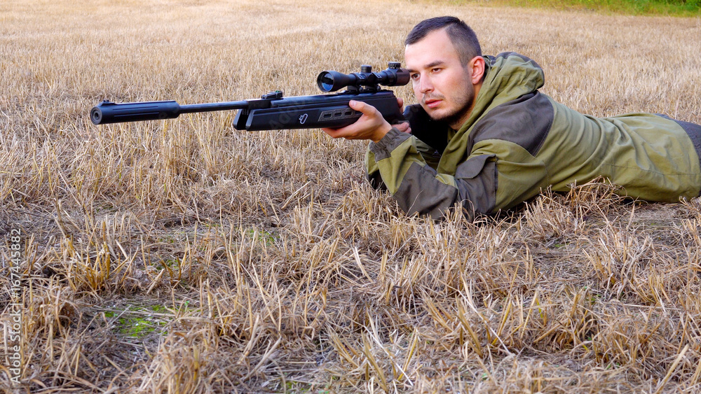 Hunter aiming a gun at wild animals Hunter aiming a gun at wild animals