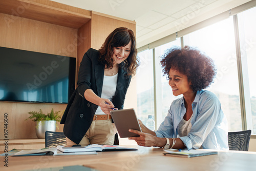 Business partners using touchscreen computer for project discuss photo