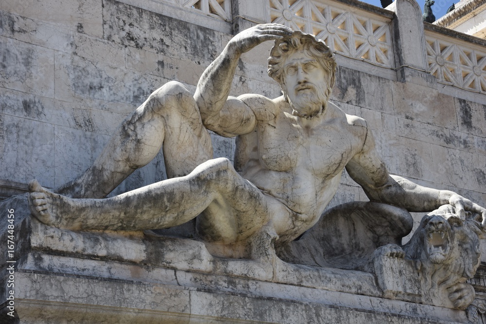 Close up of a reclining male statue 