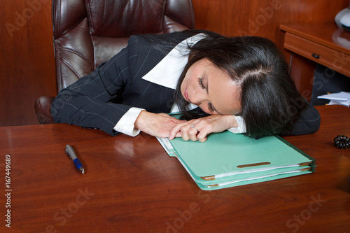 Asian American businesswoman tired at work.