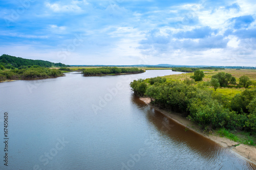 Water summer landscape: river bed and forest