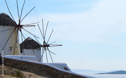 The traditional old Greek Windmills looking over Little Venice in Mykonos, Greece.
