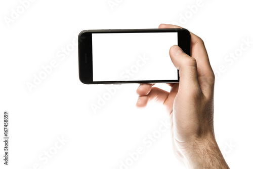 Hand holding smartphone, blank screen on white background
