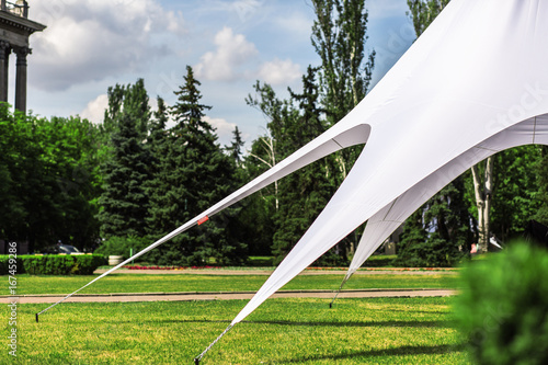 large white tent is stretched on a lawn
