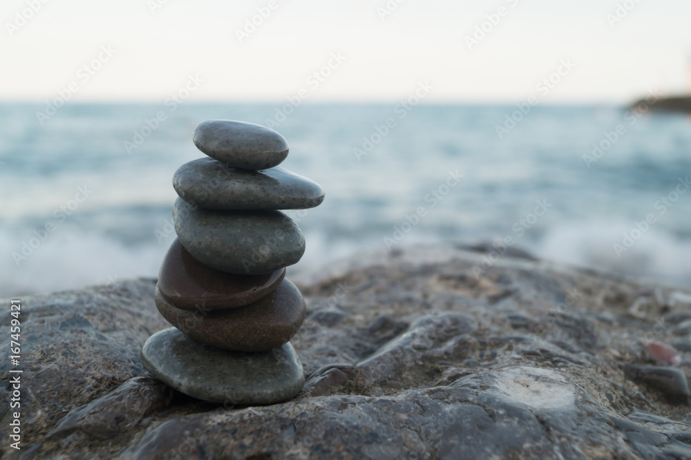 Fototapeta premium Pebble tower standing on the left on the big stone