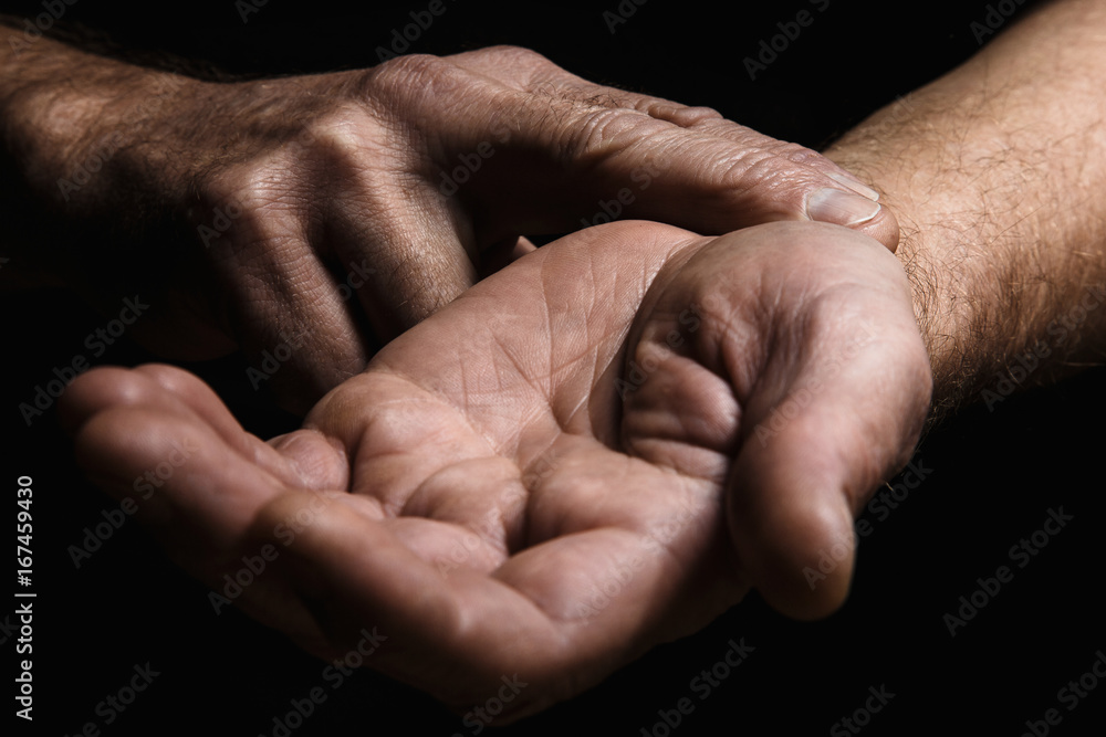 Hands of an elderly man with two fingers measuring the pulse. Lots of texture and character in the old man hands Hands of an elderly man with two fingers measuring the pulse. Lots of texture and character in the old man hands