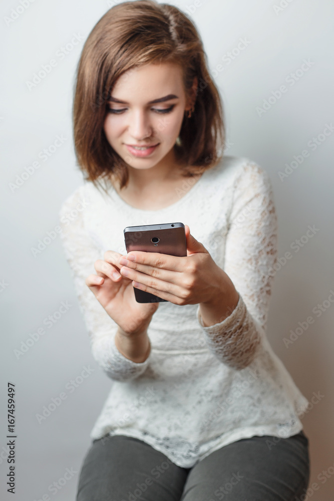 Beautiful young girl smiling communicating in social networks smartphone Beautiful young girl smiling communicating in social networks smartphone
