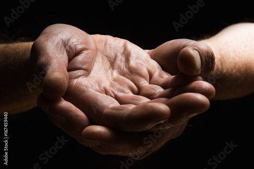 Hands of elderly men show palm on palm