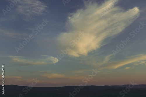Sky. Beautiful clouds over the valley. Landscape. Background with cloudy sky. Incredible view. Patterns from the clouds. Evening.