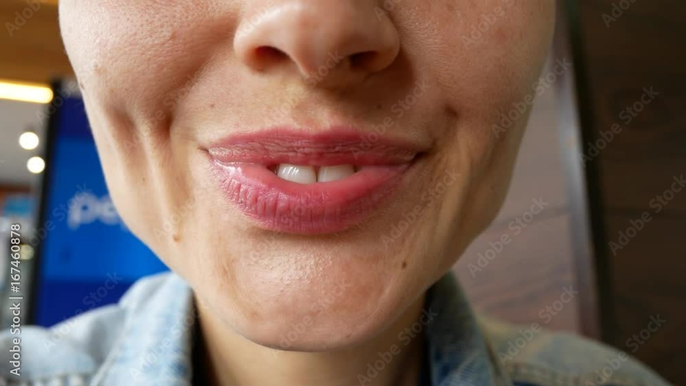 A close-up of the bottom of the female face. The girl makes a different grimace with her mouth. A close-up of the bottom of the female face. The girl makes a different grimace with her mouth.