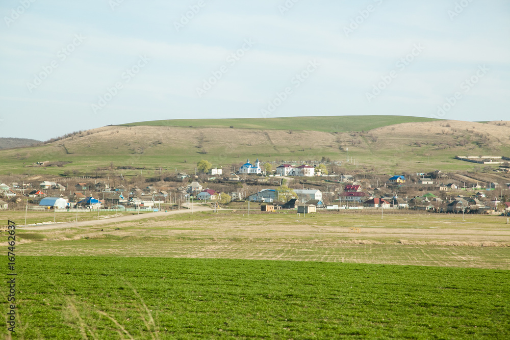 Fototapeta premium village houses with church and blue sky 