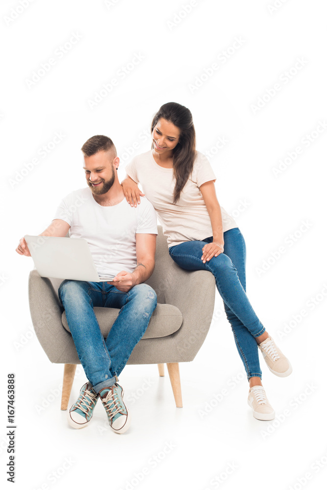 'portrait of young attractive couple using laptop, isolated on white 'portrait of young attractive couple using laptop, isolated on white