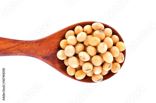 Soybeans in a wooden spoon on a white background