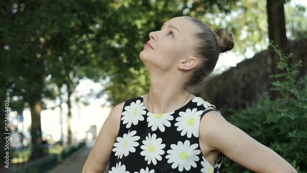 Pretty girl in floral shirt relaxing in the park and smiling to the camera, steadycam shot
Pretty girl in floral shirt relaxing in the park and smiling to the camera, steadycam shot