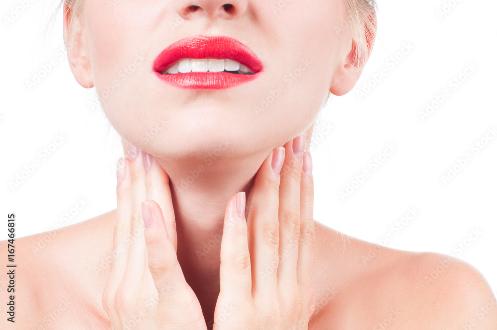 Young woman has sore throat touching the neck Young woman has sore throat touching the neck