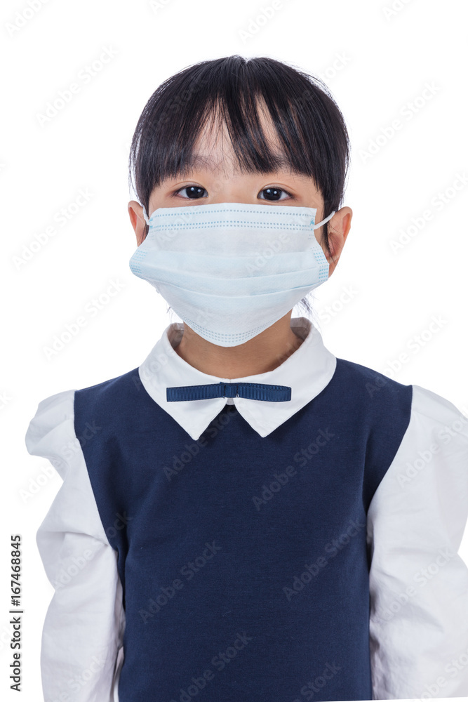 Asian Chinese little primary school girl wearing a protective mask Asian Chinese little primary school girl wearing a protective mask