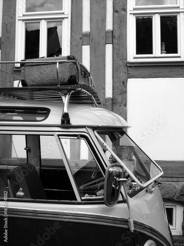 Kleinbus der Fünfziger Jahre mit Dachgepäckträger als Wohnmobil für Vanlife und Camping beim Oldtimertreffen Golden Oldies ins Wettenberg Krofdorf-Gleiberg bei Gießen in Hessen in Schwarzweiß photo