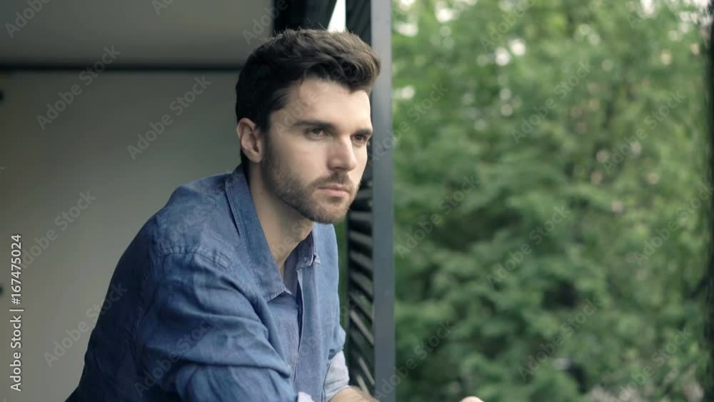 Pensive, thoughtful man standing on terrace at home
Pensive, thoughtful man standing on terrace at home