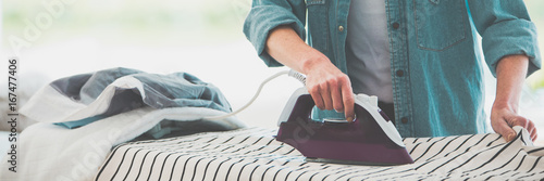 Obraz na plátne Woman ironing clothes