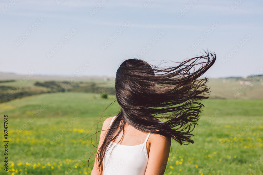 Woman portrait when the wind blow her hair covering her face Woman portrait when the wind blow her hair covering her face