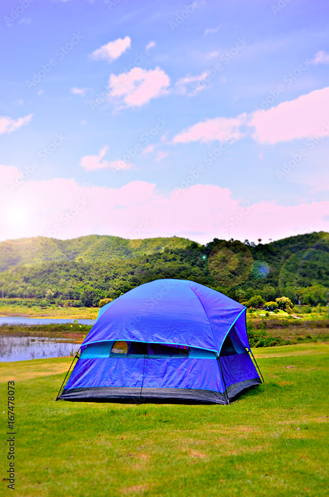 Camping Tent near mountain river in the summer, Sunrise in the morning