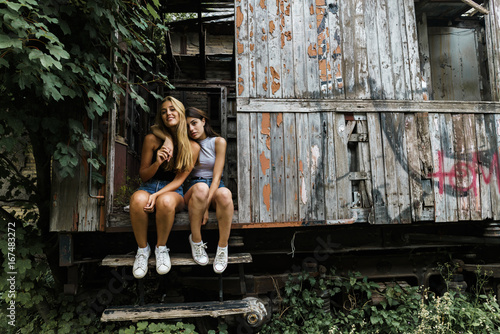 Women embracing in wrecked cabin