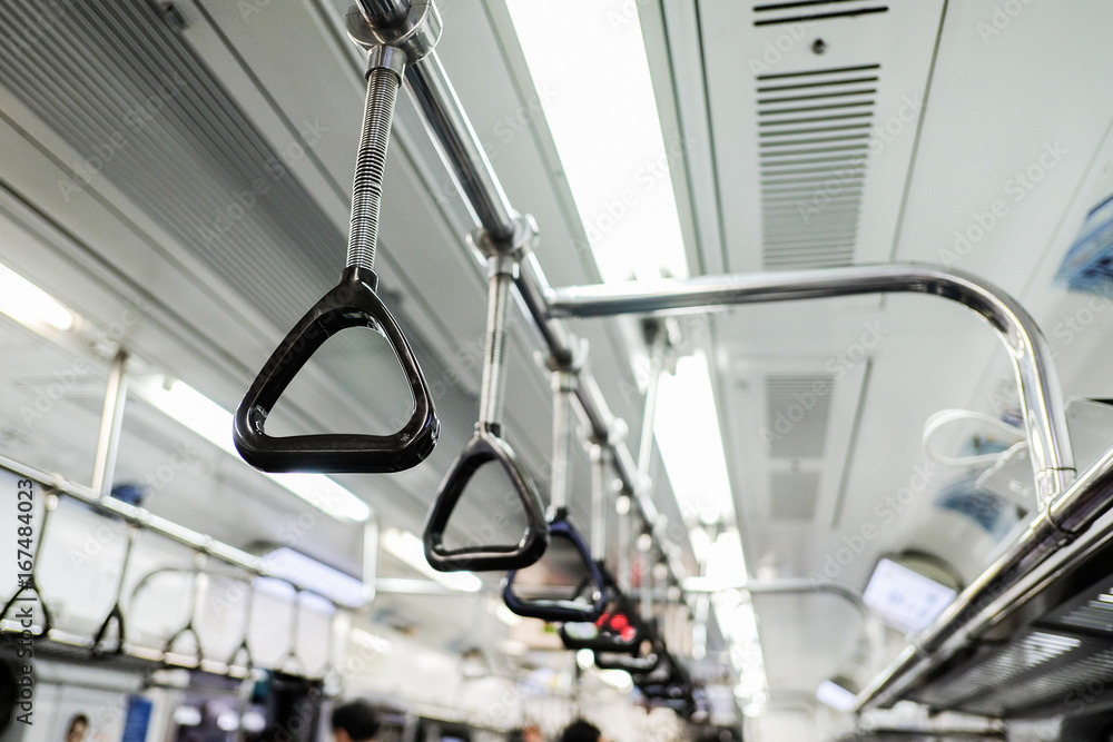 Handles on ceiling for standing passenger in a subway train Handles on ceiling for standing passenger in a subway train