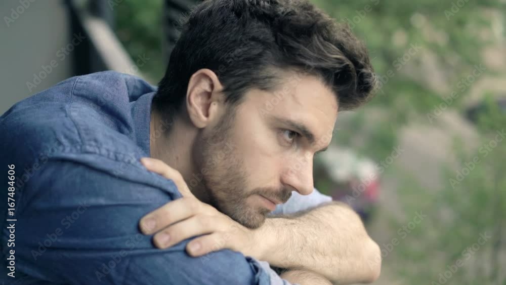 Sad, unhappy man standing on terrace at home
Sad, unhappy man standing on terrace at home