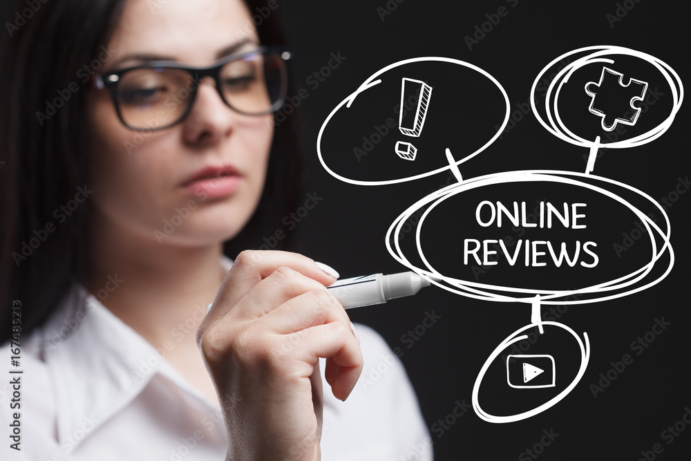 The concept of business, technology, the Internet and the network. A young entrepreneur working on a virtual screen of the future and sees the inscription: Online reviews The concept of business, technology, the Internet and the network. A young entrepreneur working on a virtual screen of the future and sees the inscription: Online reviews