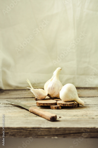 Organic garlic on a wooden rustic background, warm calm gamma.