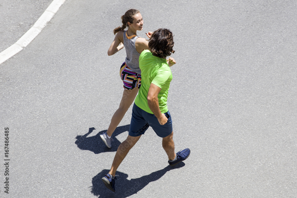 Handsome man and beautiful woman jogging together on street Handsome man and beautiful woman jogging together on street