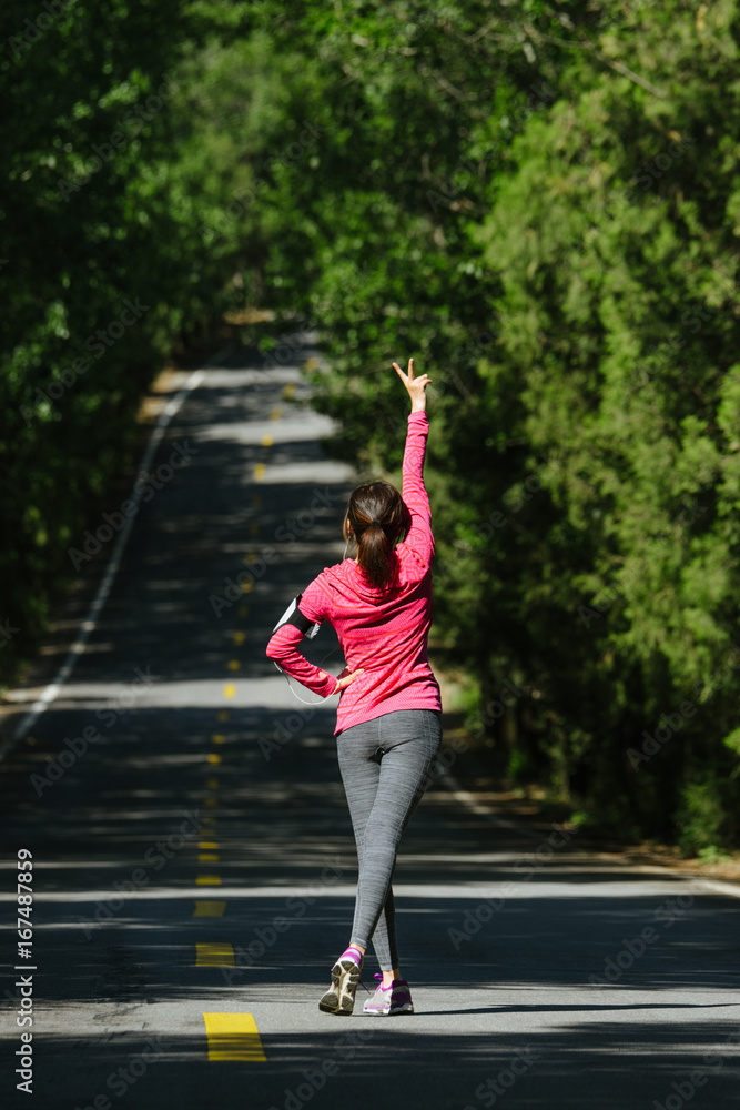 Young woman making V sign after jogging Young woman making V sign after jogging