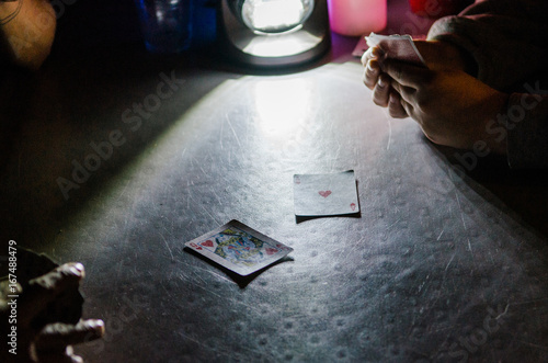 playing cards by camp lantern