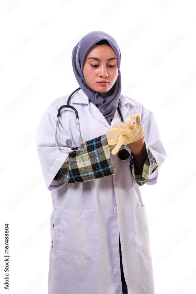 Portrait of an attractive beautiful female doctor in a white coat wearing the surgical gloves Portrait of an attractive beautiful female doctor in a white coat wearing the surgical gloves