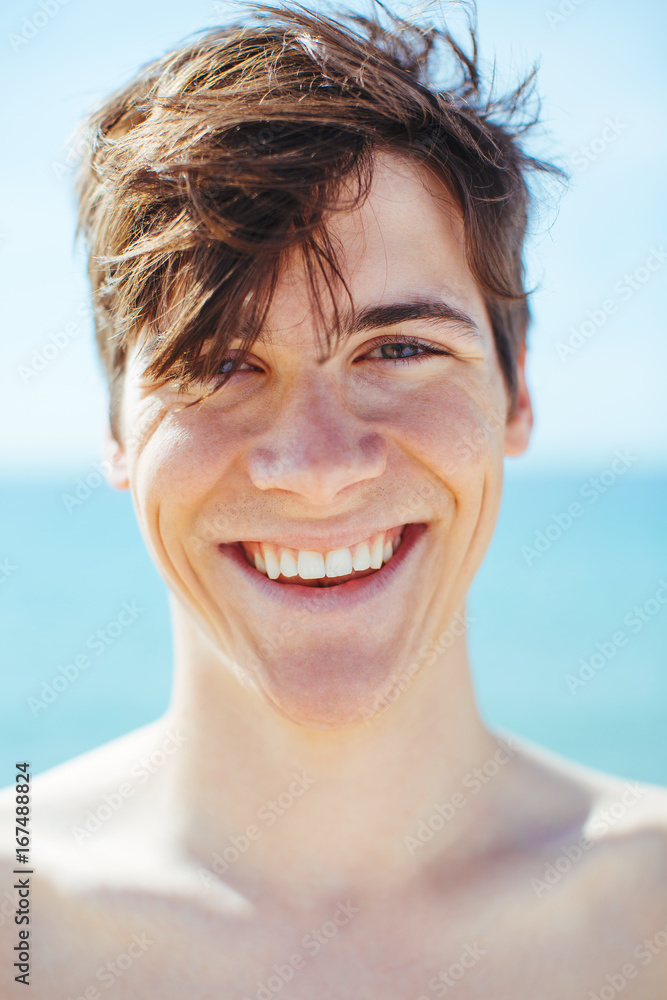 Closeup portrait of a young boy smiling on the beach. Closeup portrait of a young boy smiling on the beach.