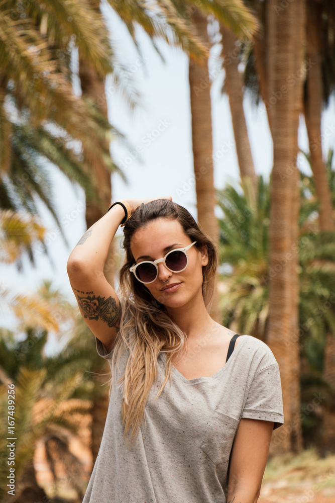 Portrait of pretty woman with palm tree in background Portrait of pretty woman with palm tree in background