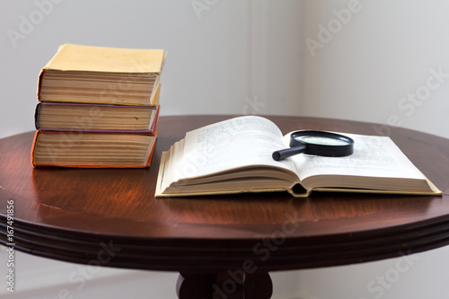 Open book and a magnifying glass