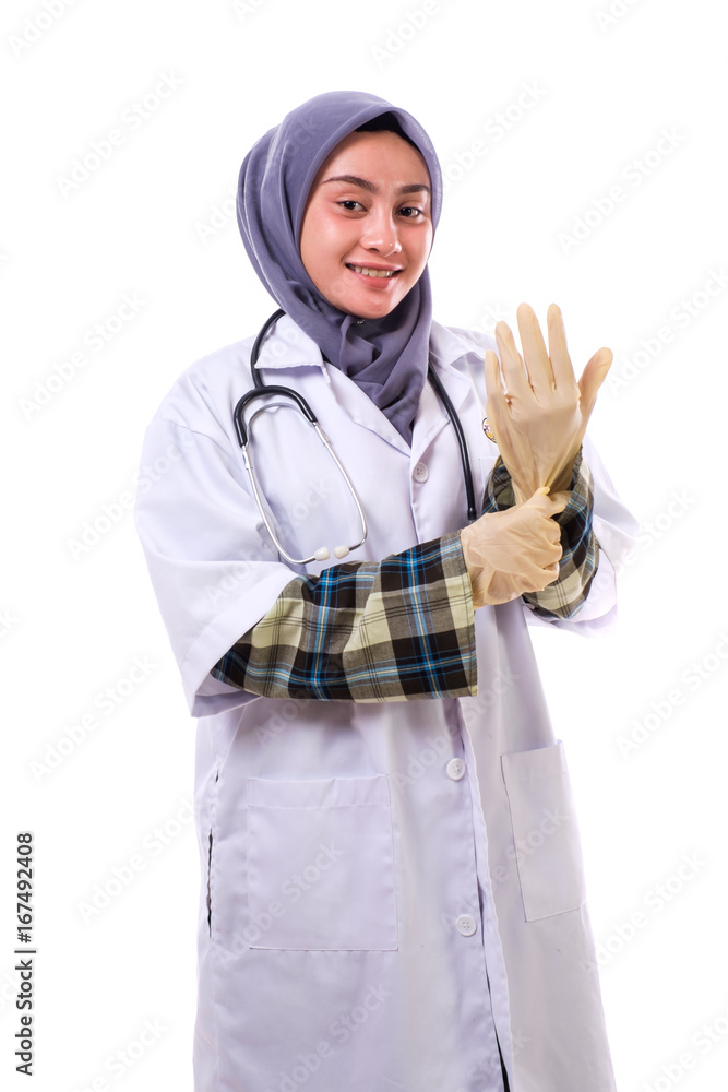 Portrait of an attractive beautiful female doctor in a white coat wearing the surgical gloves Portrait of an attractive beautiful female doctor in a white coat wearing the surgical gloves