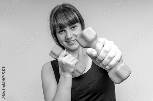 Fitness woman doing exercises with dumbbells photo