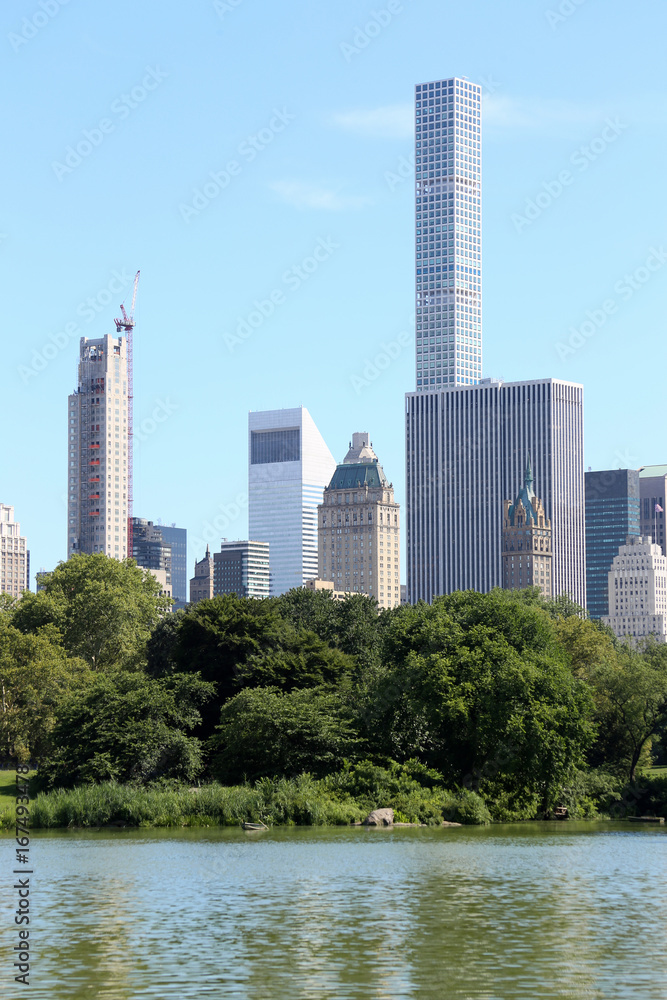 View of Manhattan skyscrapers from Central Park pond in New York City