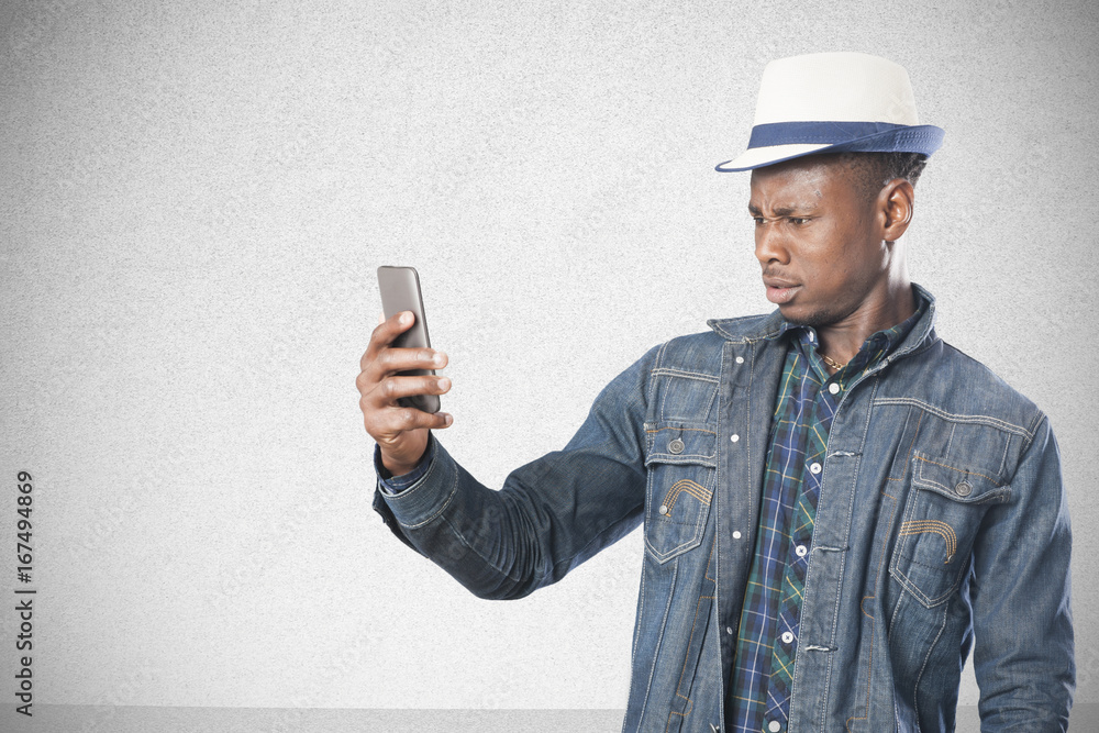 Portrait of a handsome young african man standing with a mobile phone Portrait of a handsome young african man standing with a mobile phone