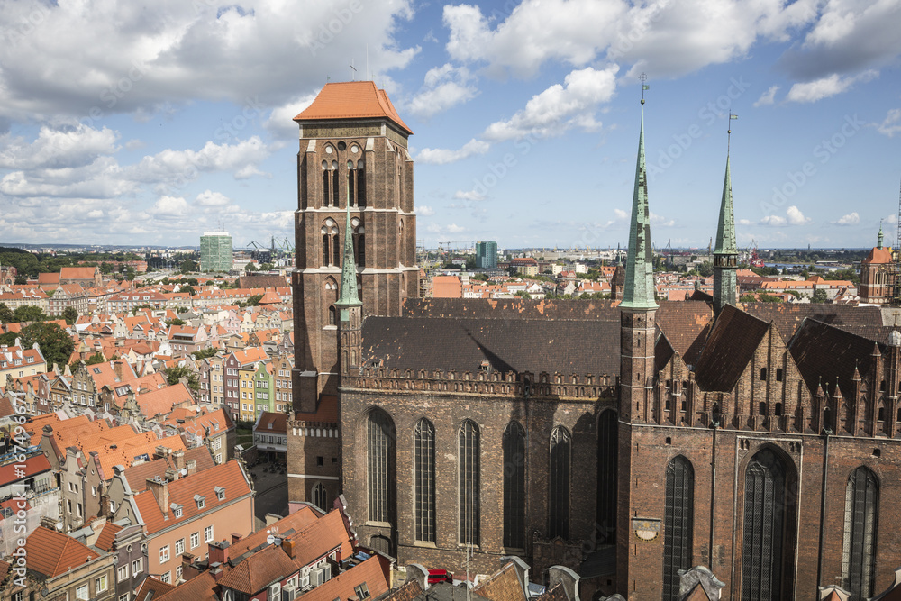 Fototapeta premium Cityscape aerial view on the old town with saint Marys church on the sunset in Gdansk, Poland