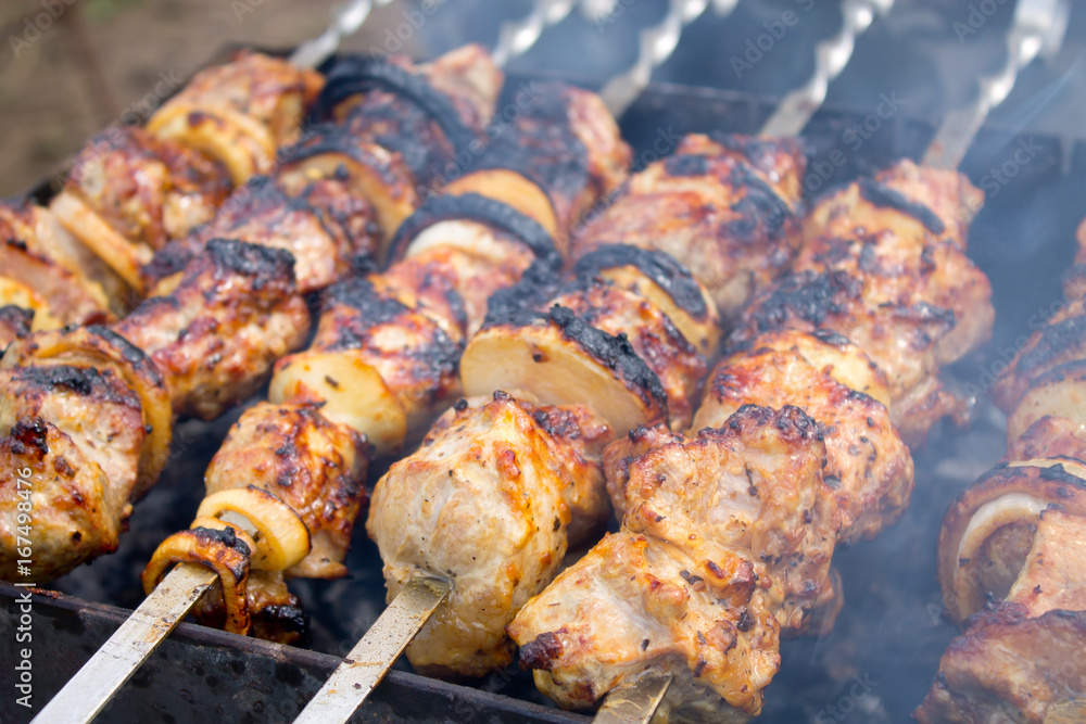 Grilled kebab cooking on metal skewer closeup Grilled kebab cooking on metal skewer closeup
