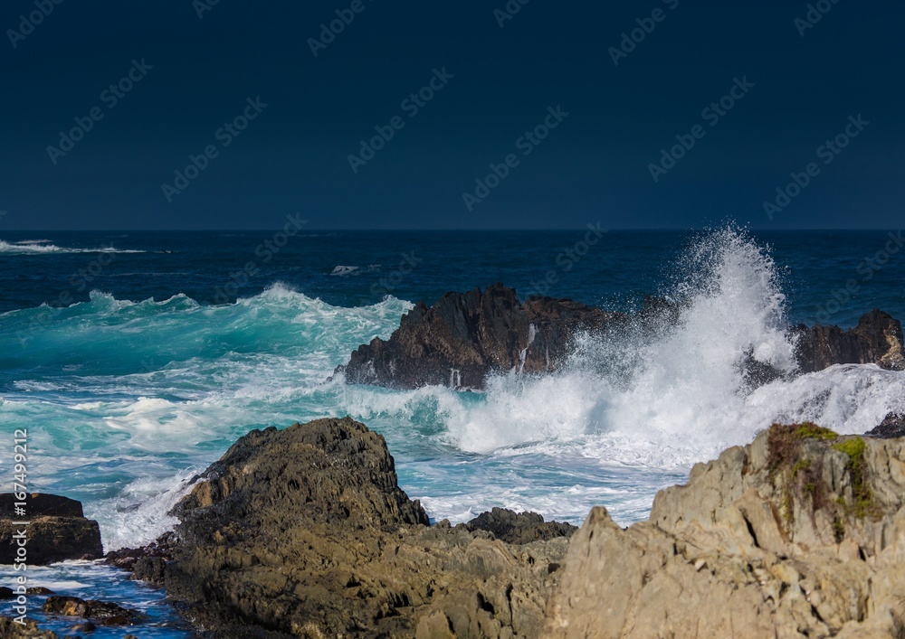 Breaking waves on the coast of the Otter Trail at the Indian Ocean Breaking waves on the coast of the Otter Trail at the Indian Ocean