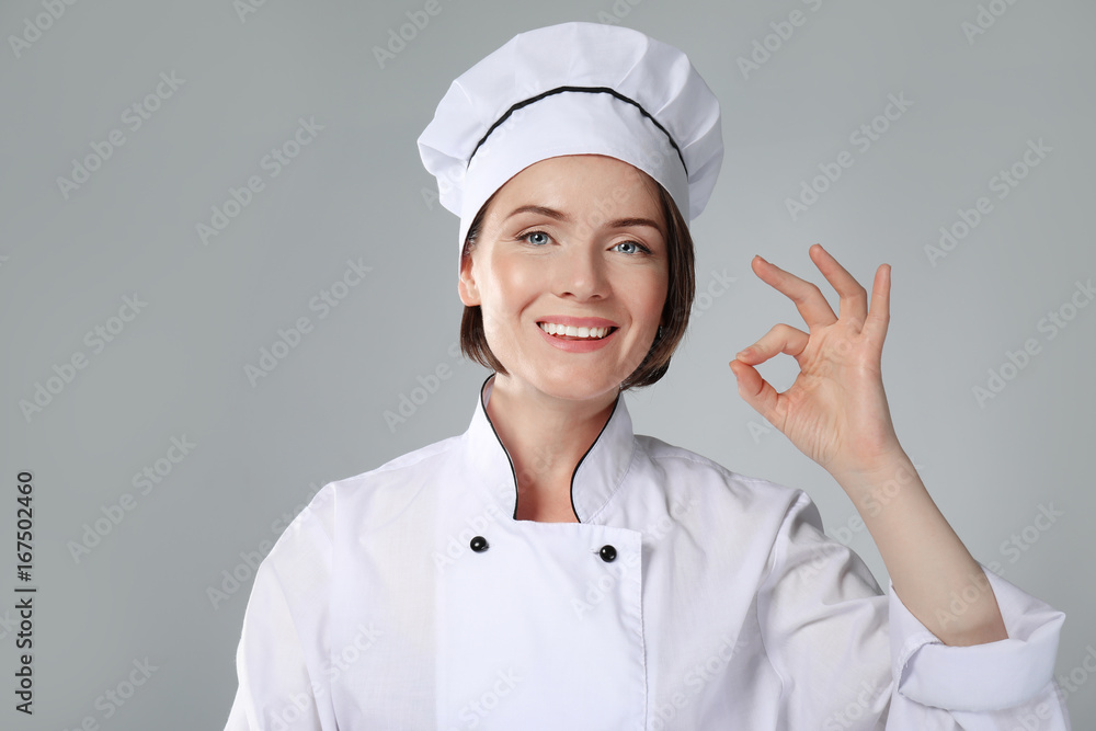 Female chef on grey background Female chef on grey background
