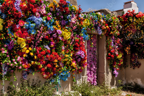 Wall covered with fake multicolored flowers